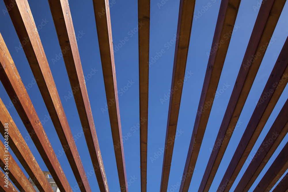 Wooden slats on a blue background. Geometric drawing.