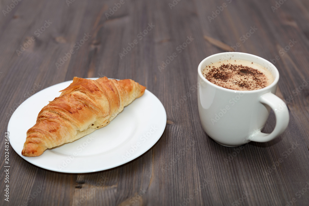 Coffee and croissant on wooden desk background top view mock up Coffee and croissant on wooden desk background top view mock up