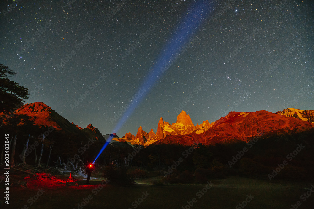 Φωτογραφία View of Mount Fitz Roy and a man with a spotlight in the National Park Los Glaciares National Park at night