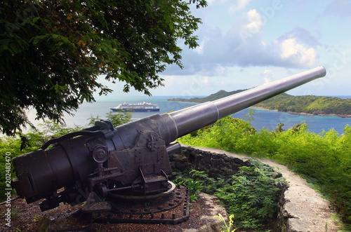 Canvas-taulu American WWII cannon in the foreground & beautiful landscape with a cruise ship in the background, Bora Bora, French Polynesia