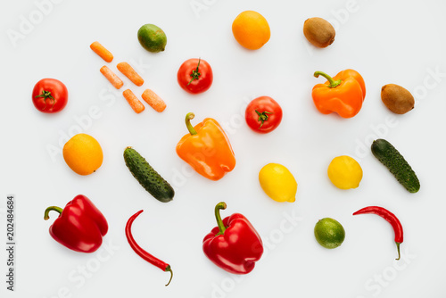 top view of pattern of colored fruits and vegetables isolated on white