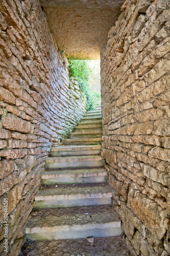 Stone entrance in old village near Garda Lake in Italy