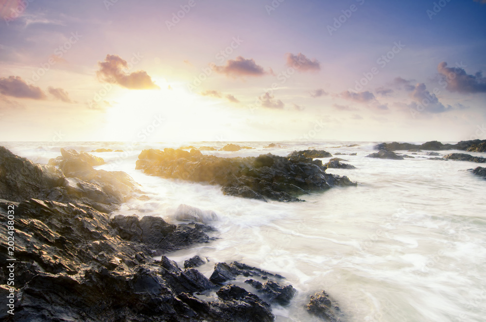 Travel and leisure concept, beautiful sea view scenery over stunning sunrise background.sunlight beam and soft wave hitting sandy beach