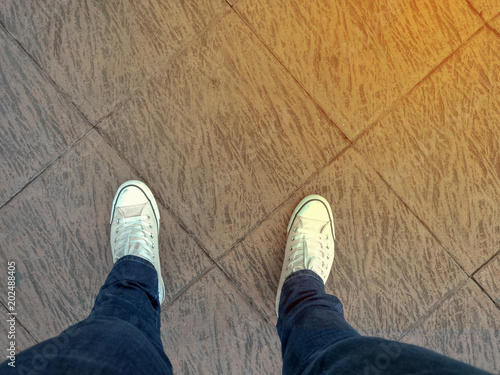 foots stand on blank floor