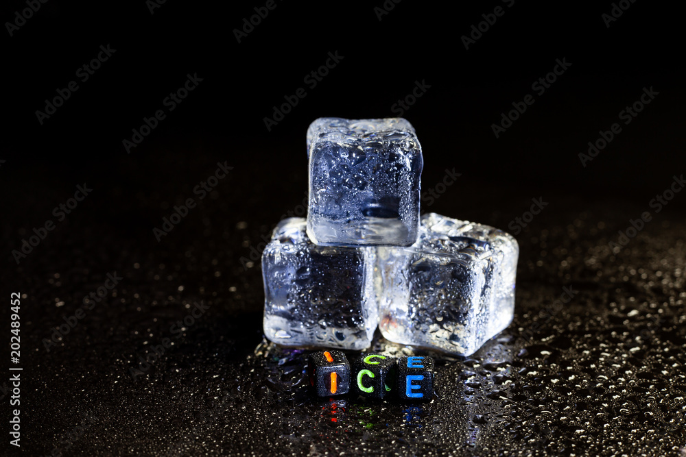 ice cubes reflection on black table background. ice cubes reflection on black table background.