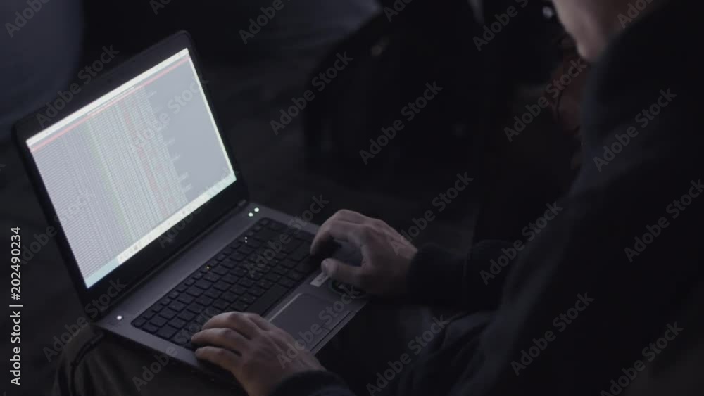 a hacker in a dark room, working behind a laptop, code on the monitor, hacker attacks, web programming and fixing viruses, crashing the site, a hacker in a dark room, working behind a laptop, code on the monitor, hacker attacks, web programming and fixing viruses, crashing the site,