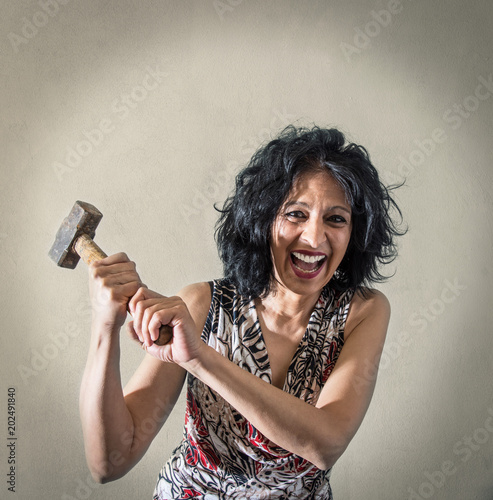 donna aggressiva che minaccia con un martello