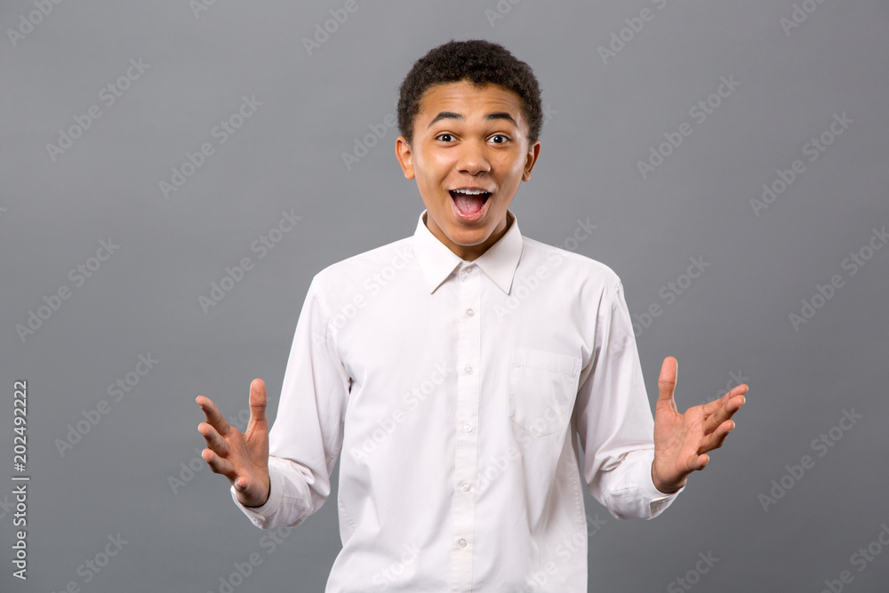 Facial expression. Joyful young man looking at you while showing his emotions Facial expression. Joyful young man looking at you while showing his emotions