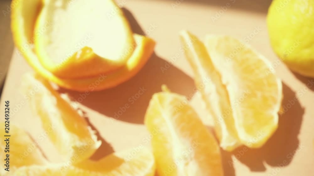 Slow motion citrus juice is poured from the carafe into a glass on a wooden table and movement of the camera Slow motion citrus juice is poured from the carafe into a glass on a wooden table and movement of the camera