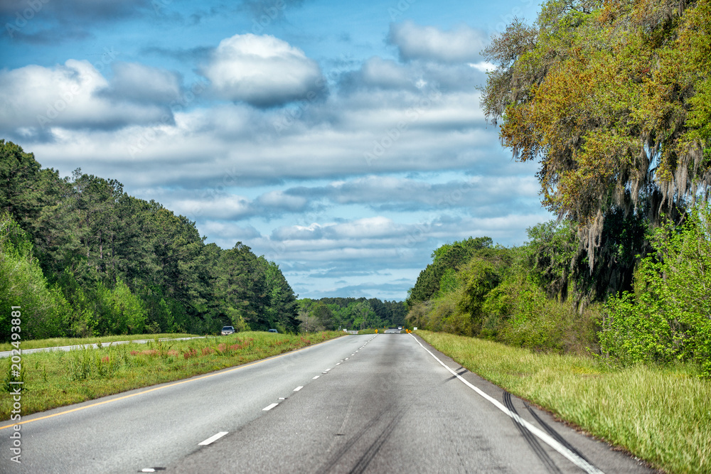 Beautiful countryside interstate road across the forest, view from the car Beautiful countryside interstate road across the forest, view from the car