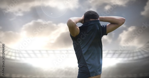 Soccer player disappointed with stadium sky photo