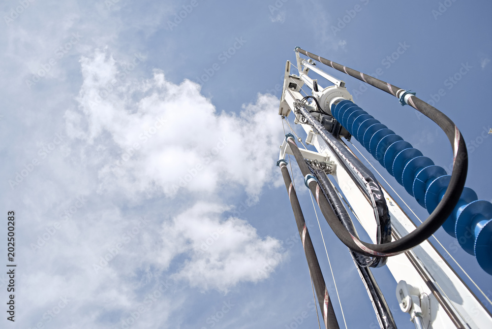 Ταπετσαρία Drilling auger for foundation piling against blue sky with clouds