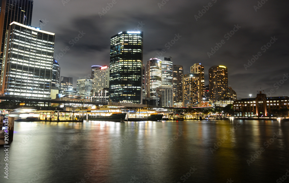 Φωτογραφία Circular Quay ferry docks in front of the central business district at night in