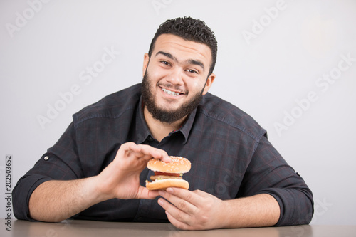 young man holds a sandwich © asem arab