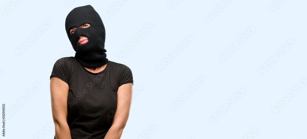 Burglar terrorist woman wearing balaclava ski mask thinking and looking up  expressing doubt and wonder isolated blue background фотография Stock |  Adobe Stock