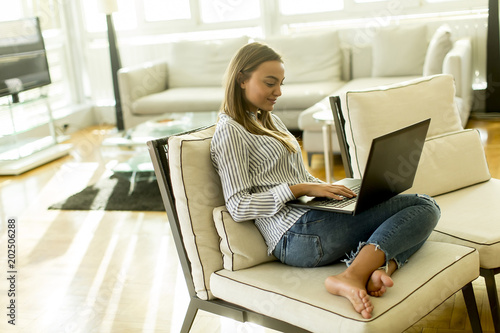 Smiling woman with a laptop...