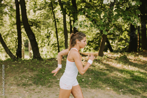 Young woman running in park...