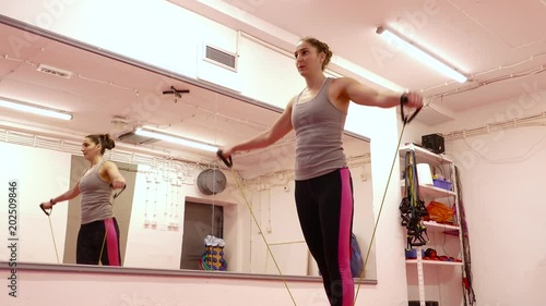 Young brunette woman doing exercises in the gym.