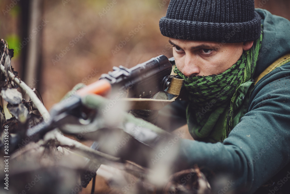 terrorist with automatic rifle. dangerous and criminal concept terrorist with automatic rifle. dangerous and criminal concept