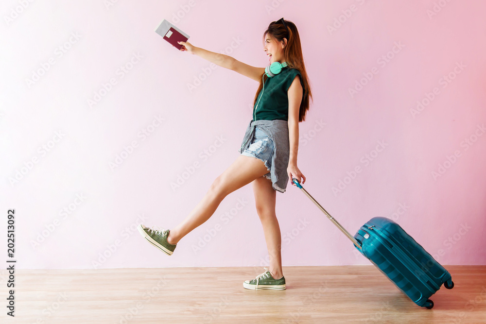 Φωτογραφία Happy Young Traveler Woman Walking with Suitcase and Music Headphone, Face looki