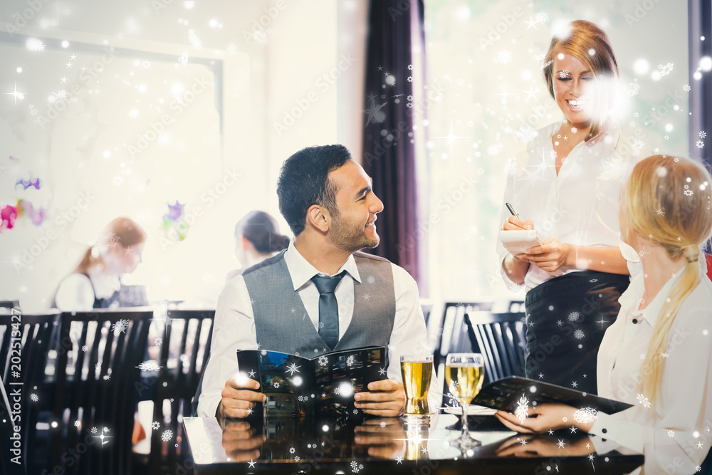 Composite image of business people ordering dinner against snow falling