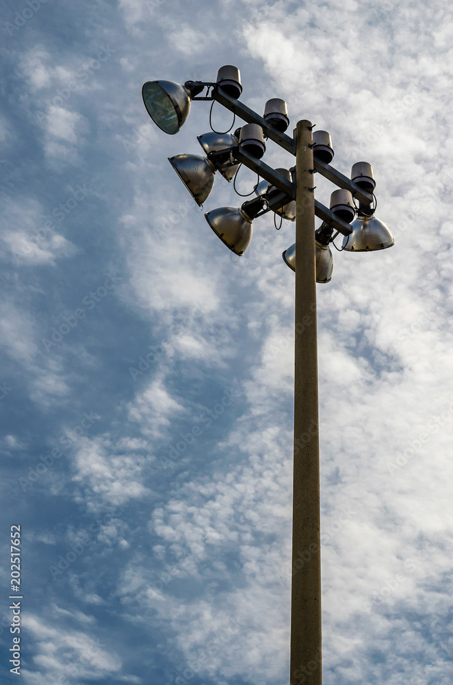 Vertical frame of sports field stadium lights against the sky Vertical frame of sports field stadium lights against the sky