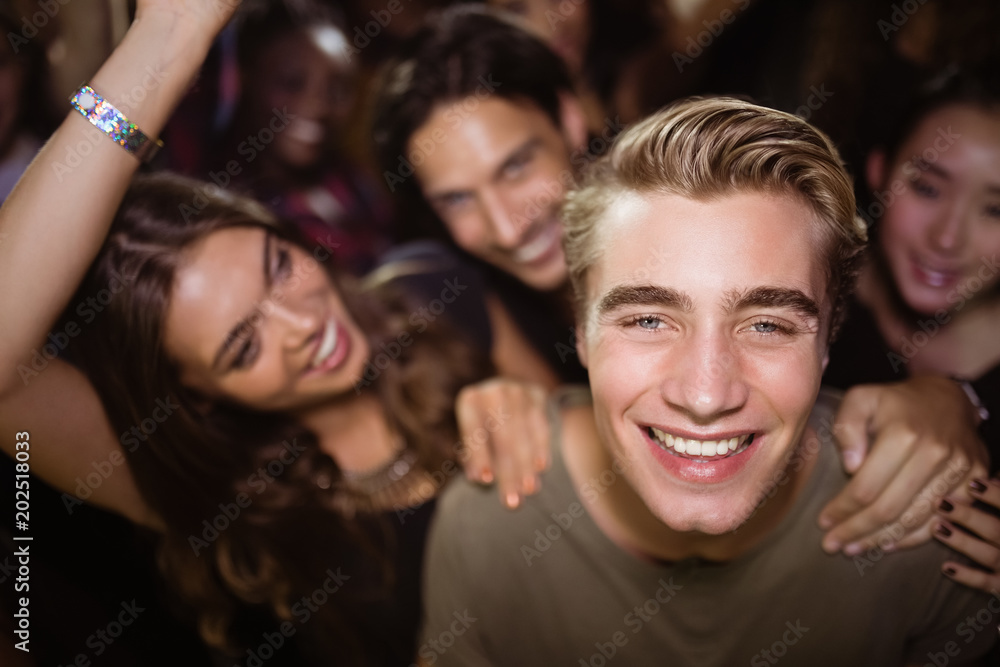 Portrait of happy man with friends at nightclub Portrait of happy man with friends at nightclub