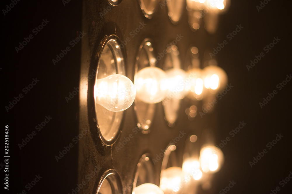Light bulbs background over dark wall, blur Light bulbs background over dark wall, blur