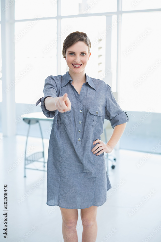 Casual young businesswoman posing in office Casual young businesswoman posing in office