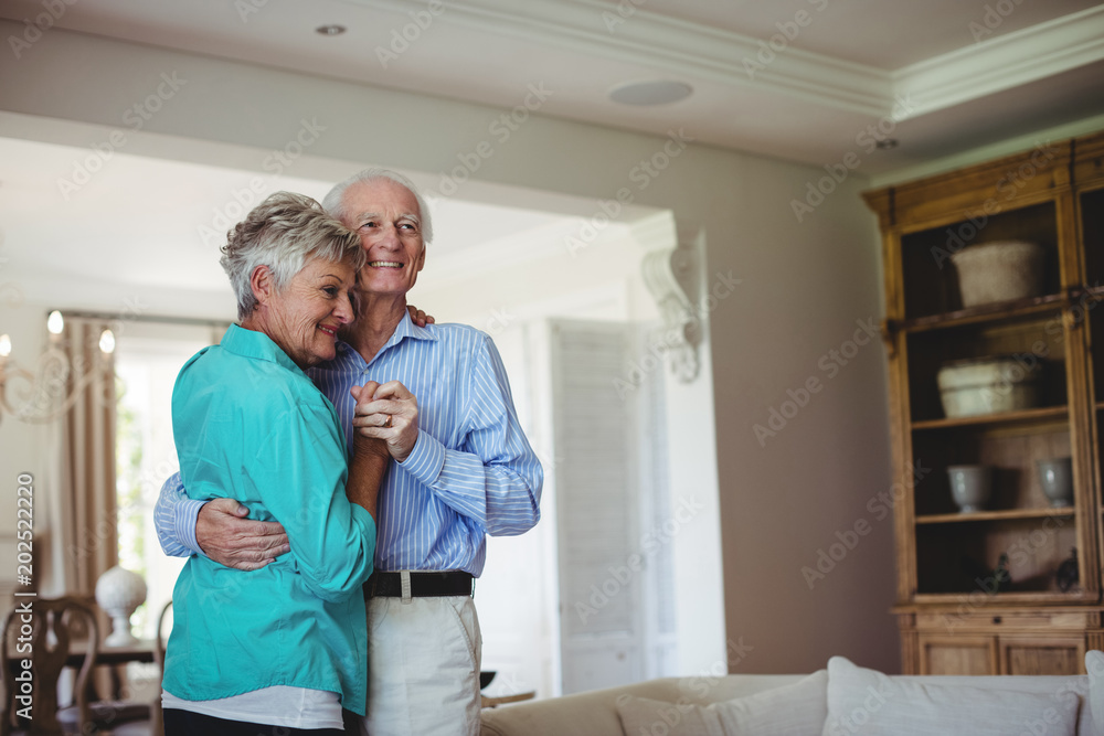 Fototapeta premium Senior couple dancing together in living room