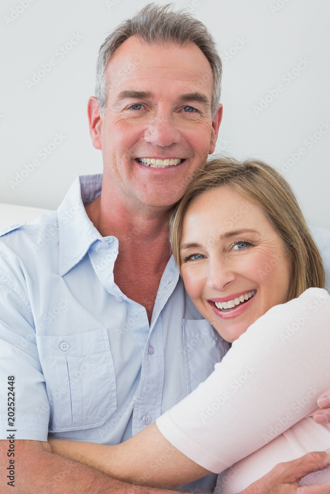Portrait of a happy couple embracing at home