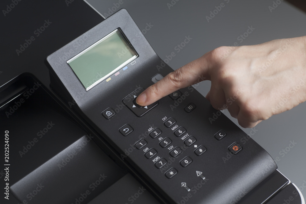 Woman's hands pressing button on Control panel laser color printer Woman's hands pressing button on Control panel laser color printer