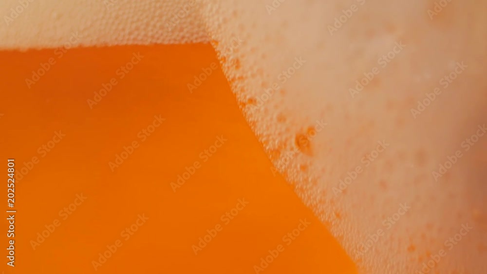 Pouring fresh beer with foam running down, slowmotion footage Pouring fresh beer with foam running down, slowmotion footage
