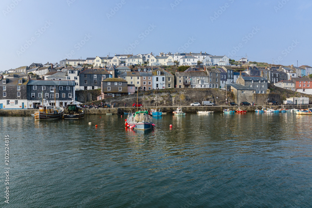 Mevagissey harbour with boats at anchor the village is a popular destination for tourists and lies within the Cornish Area of Outstanding Natural Beauty