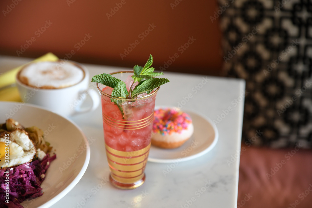 Pink drink with mint garnish in cafe Pink drink with mint garnish in cafe