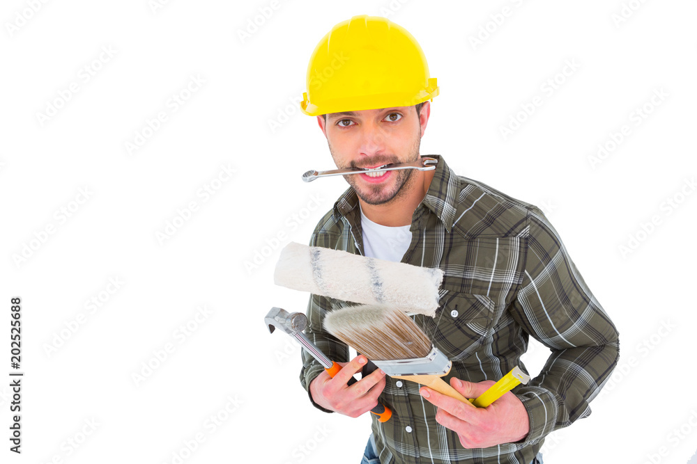 Manual worker holding various tools