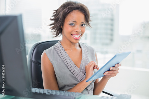 Free Download Beautiful businesswoman using her tablet pc and smiling at camera - GFXLoad