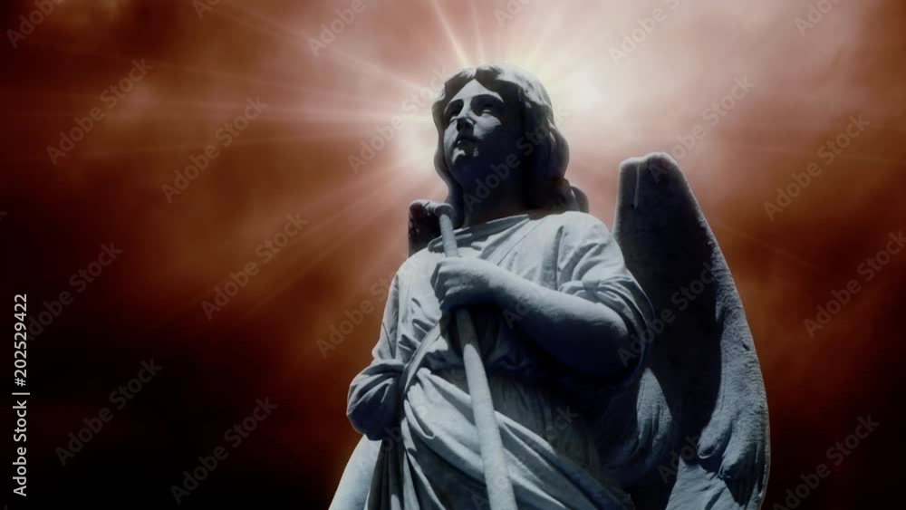 The statue of an Angel on time lapse clouds (Loop). The statue of an Angel on time lapse clouds (Loop).