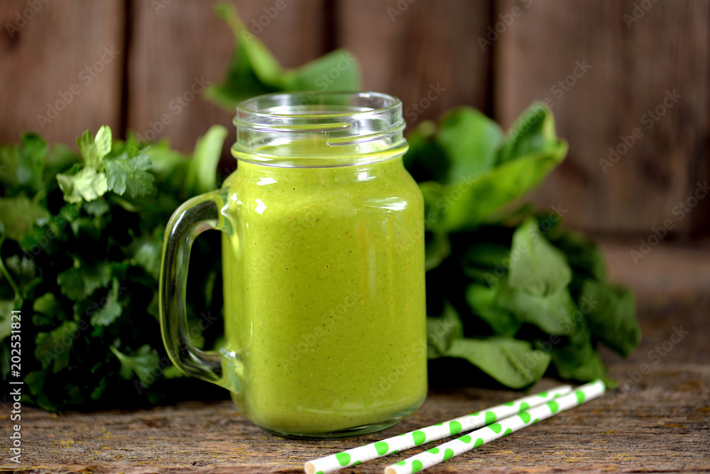 Healthy smoothies in mason jar from spinach, cucumber, celery, apple, parsley with olive oil Healthy smoothies in mason jar from spinach, cucumber, celery, apple, parsley with olive oil