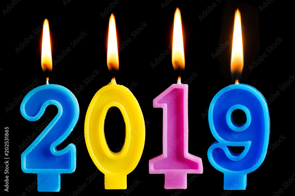 Burning candles in the form of 2019 for cake isolated on black background. The concept of celebrating the happy new year, cake decoration Burning candles in the form of 2019 for cake isolated on black background. The concept of celebrating the happy new year, cake decoration