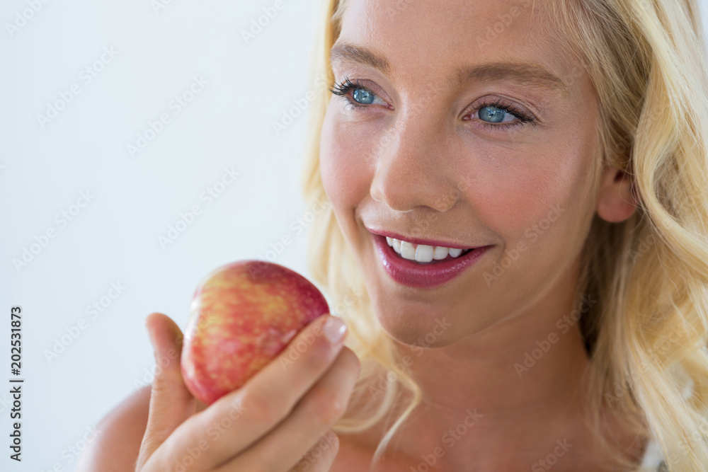 Close-up of beautiful woman holding red apple Close-up of beautiful woman holding red apple