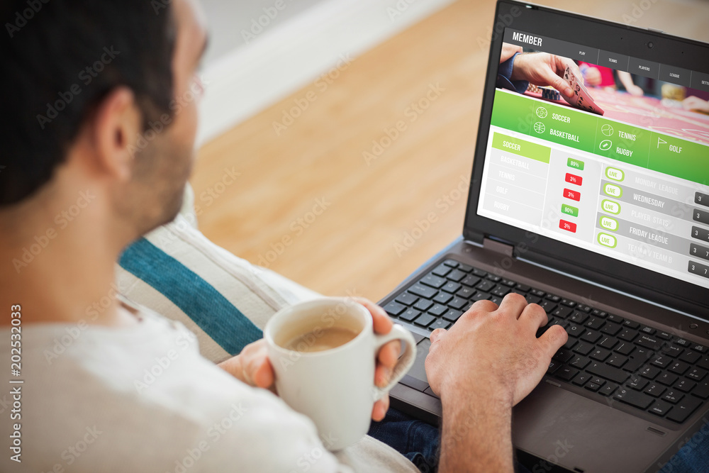Man using laptop against gambling app screen Man using laptop against gambling app screen
