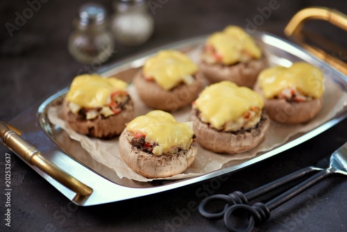 Champignons stuffed with vegetables and cheese.