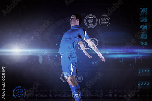 Football player in blue jumping against blue dots on black background