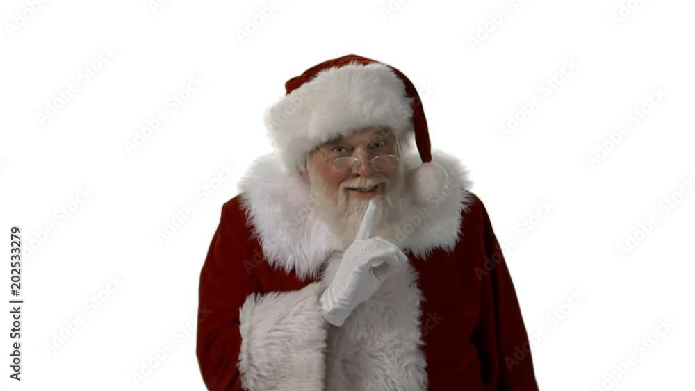 A mid shot of Santa looking into the camera and motioning with his finger to be quiet on a white background A mid shot of Santa looking into the camera and motioning with his finger to be quiet on a white background