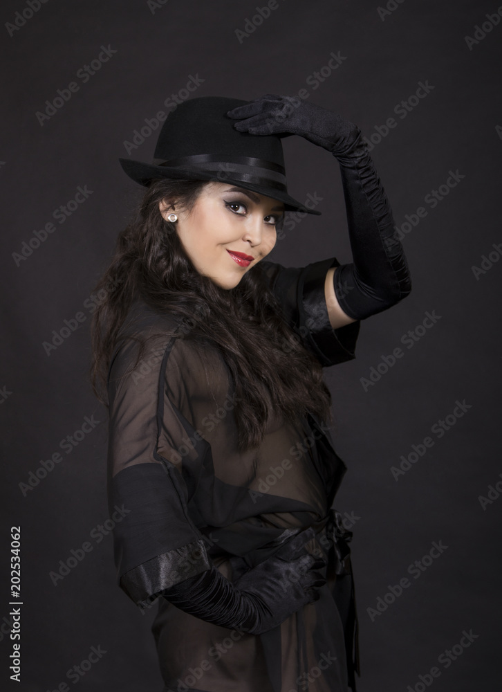 Beautiful young girl in black tunic, black gloves and black hat. Beautiful young girl in black tunic, black gloves and black hat.