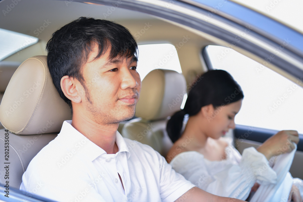 Travel Concepts. Family is driving on the road. Family drive safely with caution. Parents care baby in the car. Travel Concepts. Family is driving on the road. Family drive safely with caution. Parents care baby in the car.