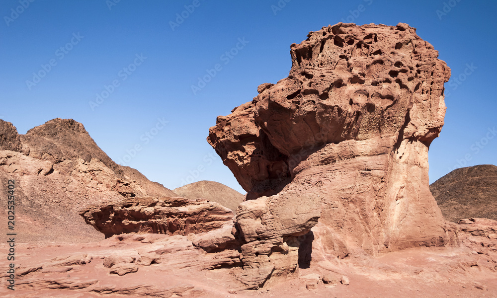 red sandstone rock formation called the Mushroom and a Half in Timna Park in Israel
