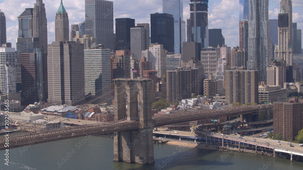 AERIAL: Famous Brooklyn Bridge against Lower Manhattan downtown cityscape