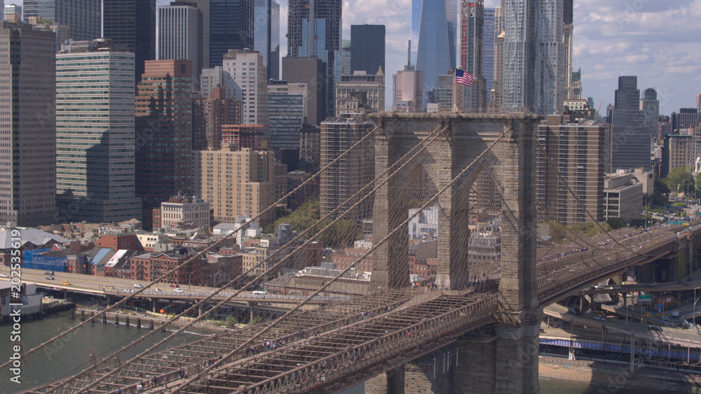 AERIAL: Magnificent Brooklyn Bridge against Lower Manhattan downtown cityscape